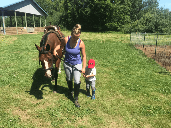 Jeannie with her son and horse outdoors