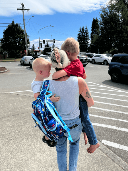 Jeannie carrying her kids