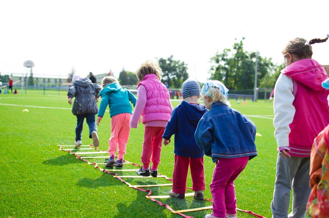 Kids playing on a green field