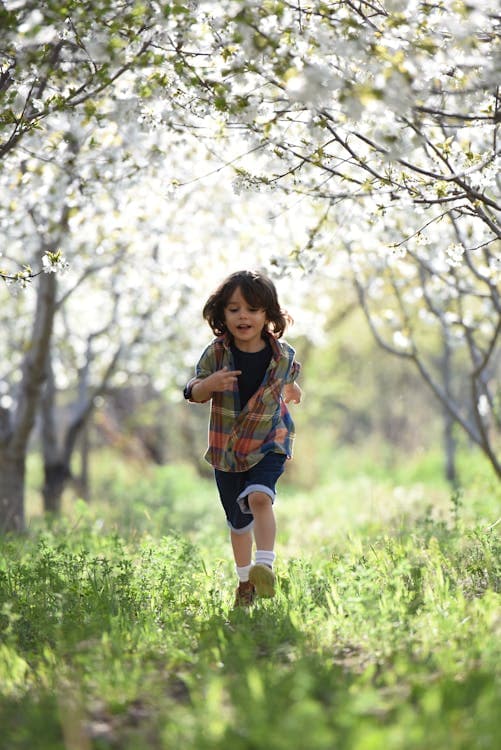 Child running through a sunlit field
