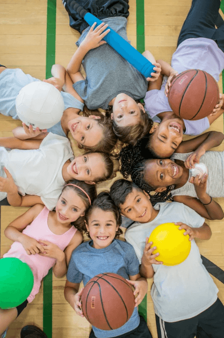 Group of kids posing together after PE class