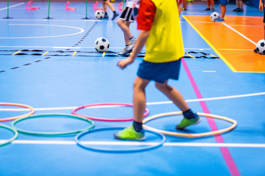 Kids running a sports obstacle course